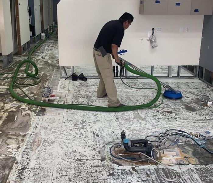 Photo of a person steam cleaning a dental office.