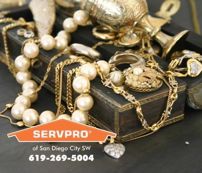 A jewelry box is shown overflowing with generations of family jewelry. 