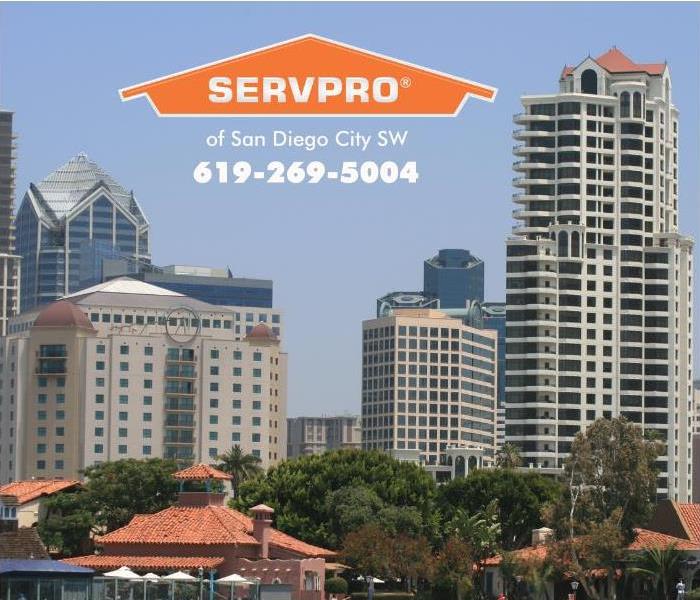 The San Diego city skyline is shown with lots of tall buildings on a sunny day.   