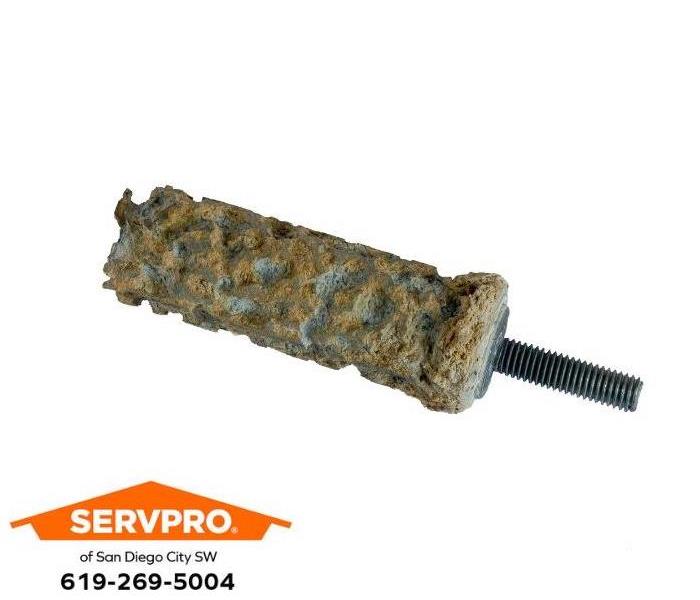 A corroded water heater anode rod is shown.